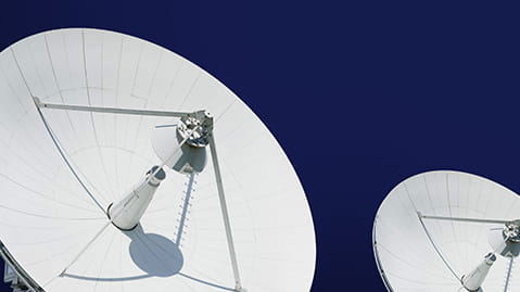 Large white satellite array against a blue sky