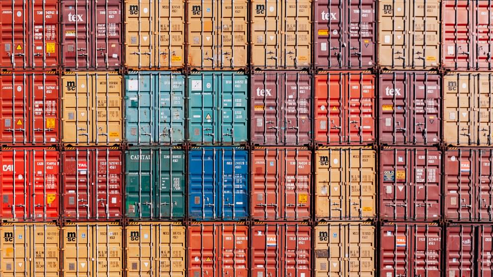 Shipping containers stacked into rows, end on
