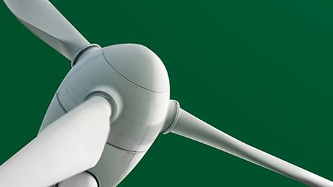 Close up of white wind turbine on a green background