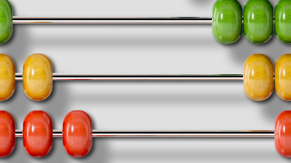 Close up view of an abacus with green, yellow and red counters