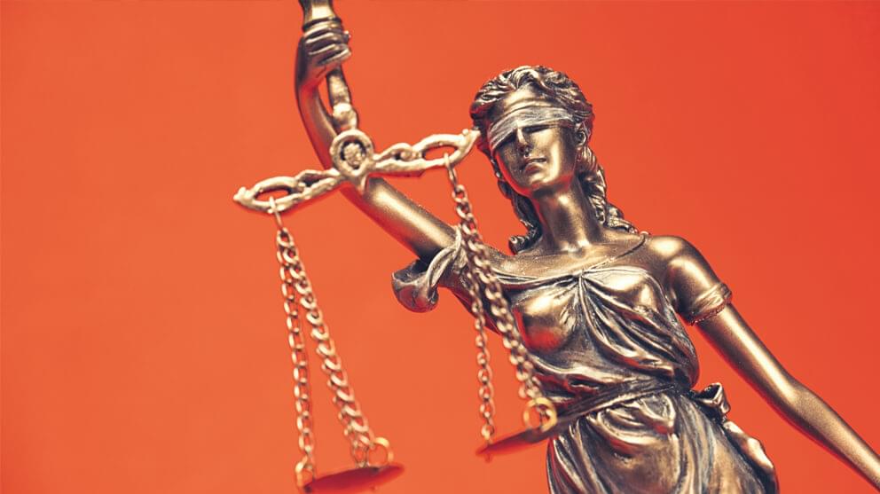 Close up of lady of justice on orange background