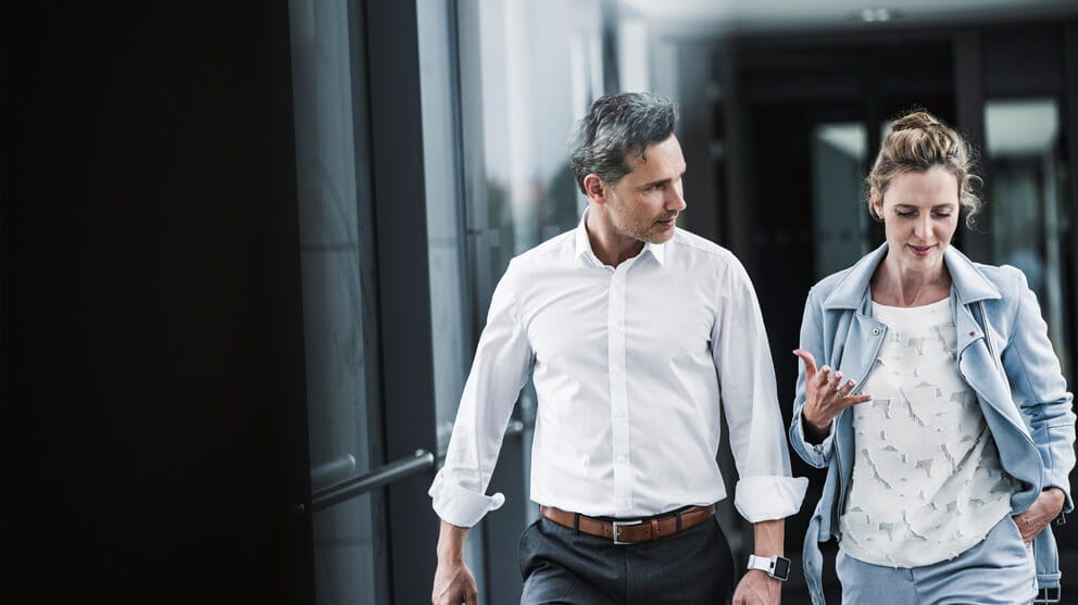 Business people talking in passageway
