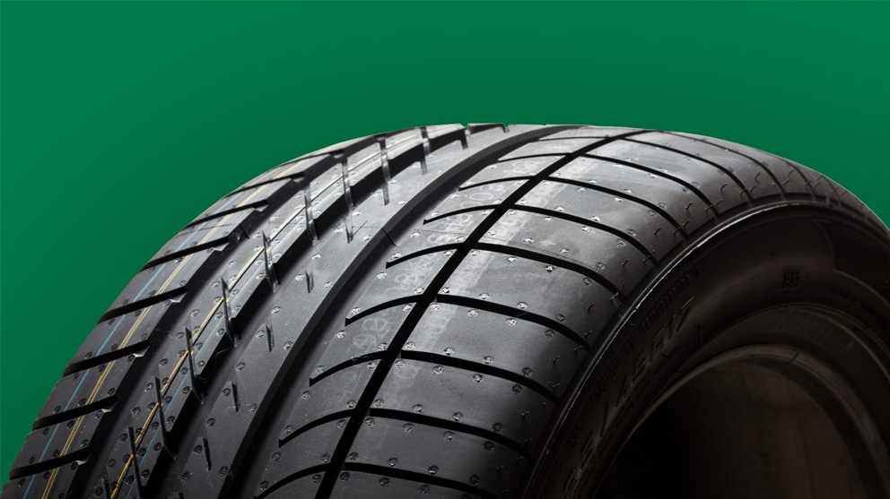 Tire on green background