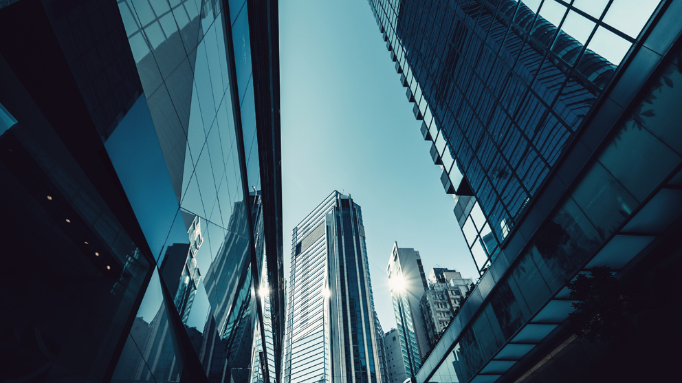 Tall glass city buildings - corporate M&A