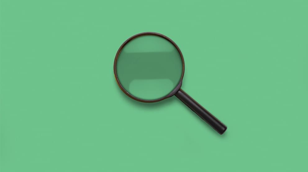 close up magnifying glass on green background