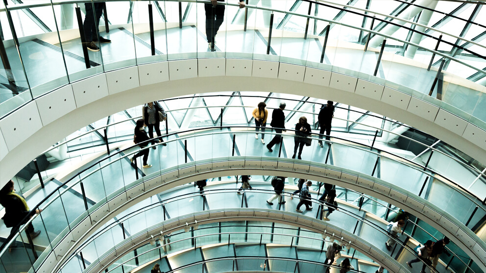 People walking on modern spiral staircase