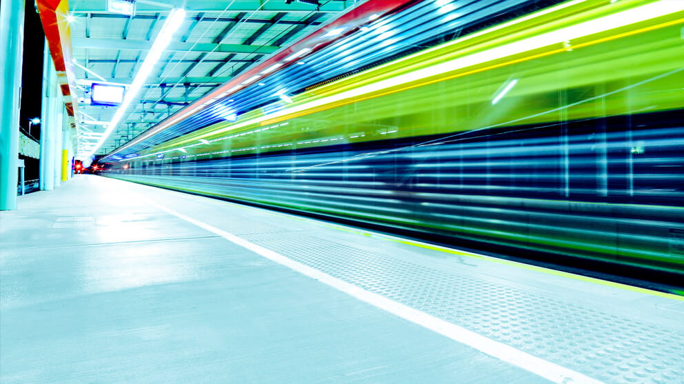 Train in motion through station