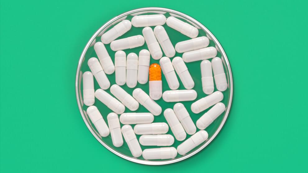 Capsule in Petri Dish on green background